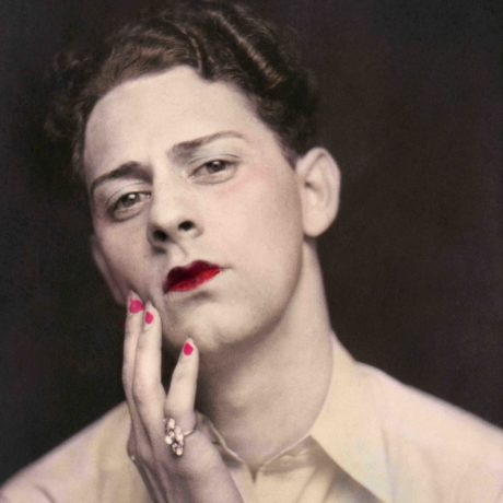 Man in makeup wearing ring. Photograph from a photo booth, with highlights of color. United States, circa 1920. © Sebastian Lifshitz Collection