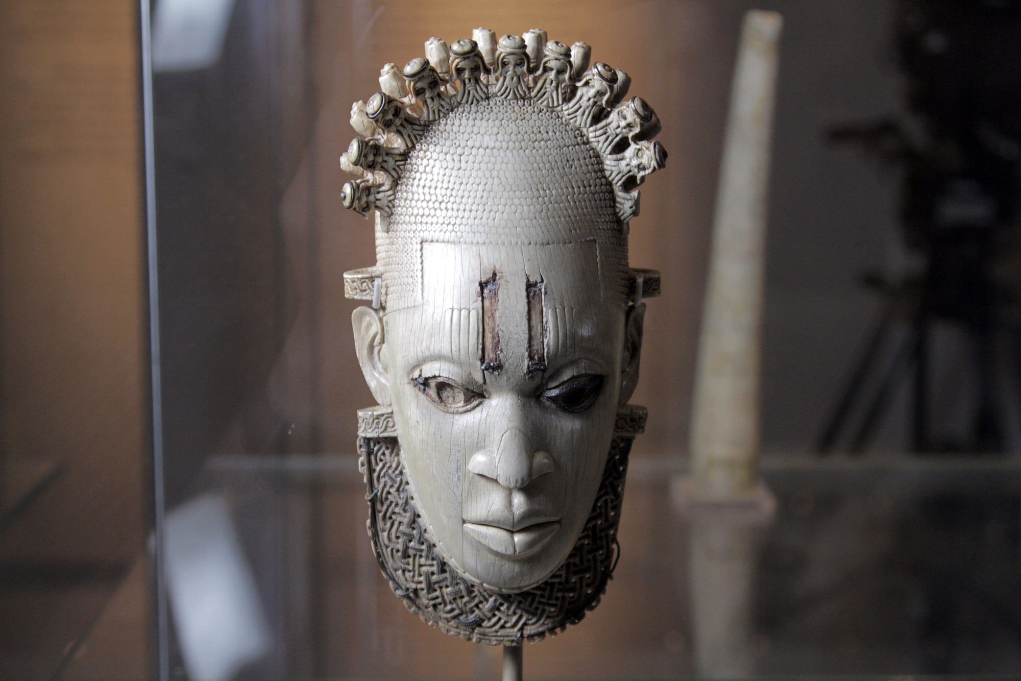 Carved Ivory mask-shaped hip pendant, inlaid with bronze Benin, Queen Idia, Artisit Unknown (16th century) British Museum, London. Photographer: Nutopia