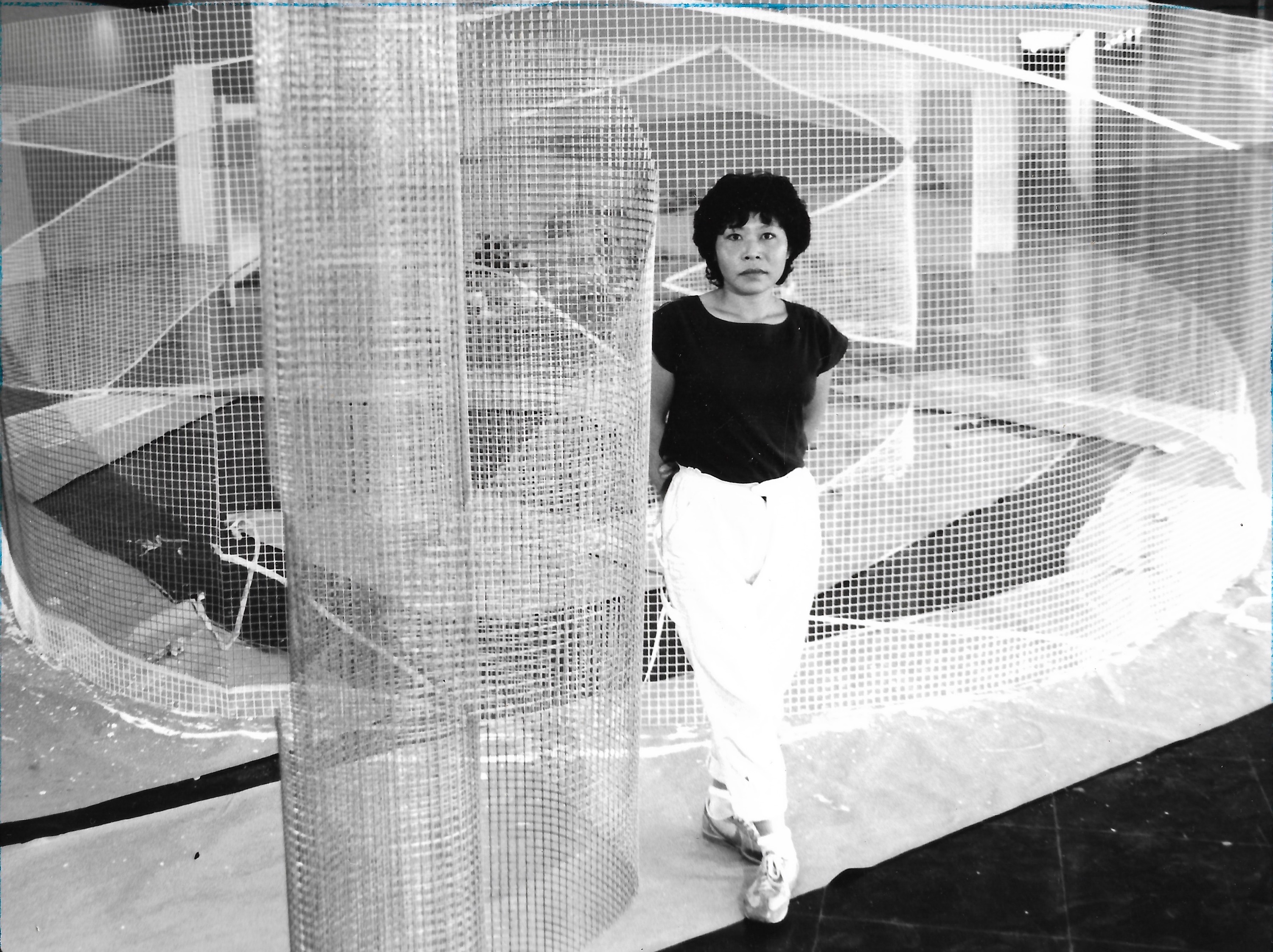 Lydia Okumura in front of her sculpture Labyrinth, Museu de Arte Moderna, São Paulo, 1984