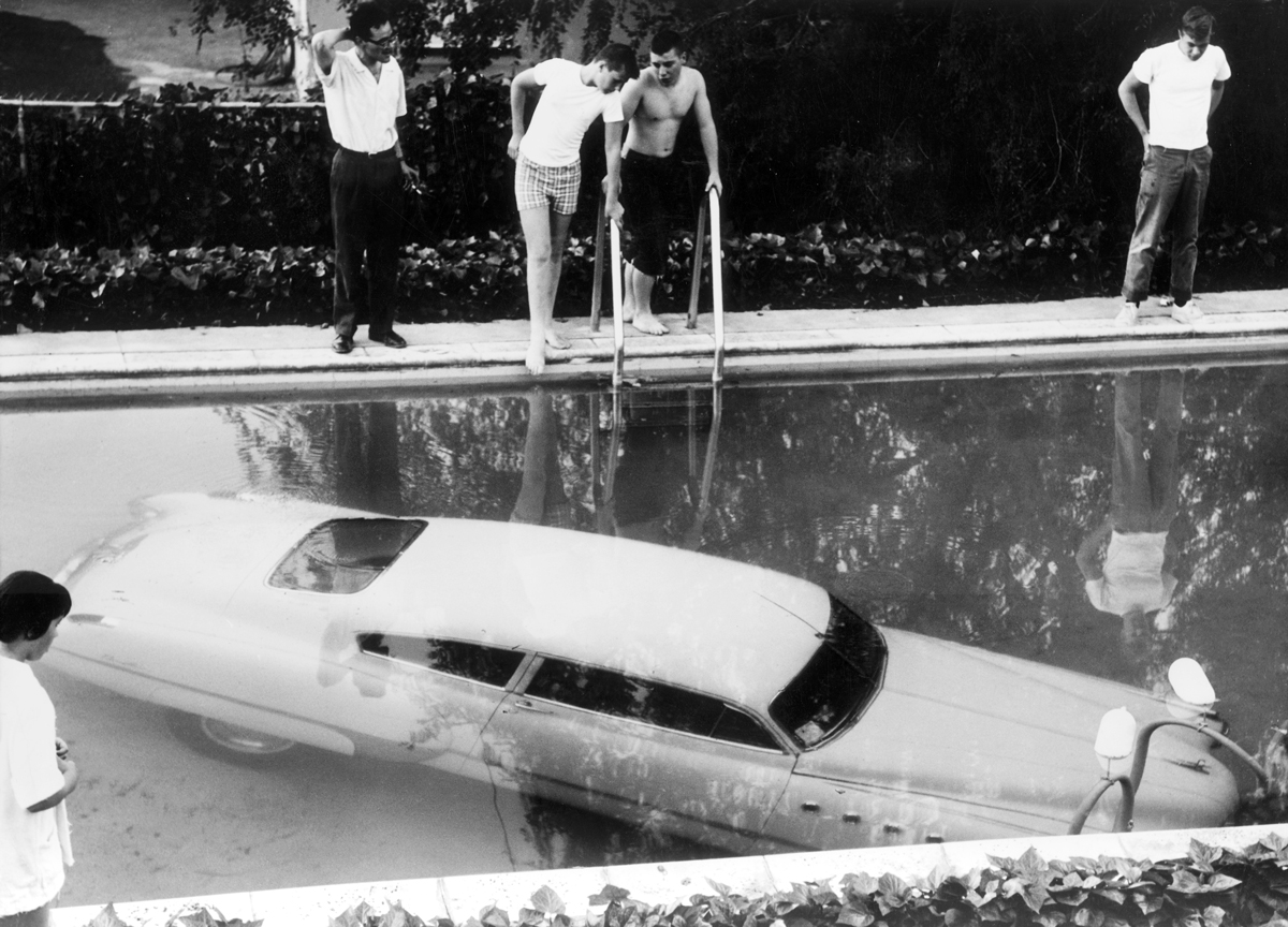 4th May 1961: A submerged car which its drunken owner 'parked' in a swimming pool in Beverly Hills, California, believing it to be a parking space. Nobody was injured in the process. Photo by Keystone/Getty Images