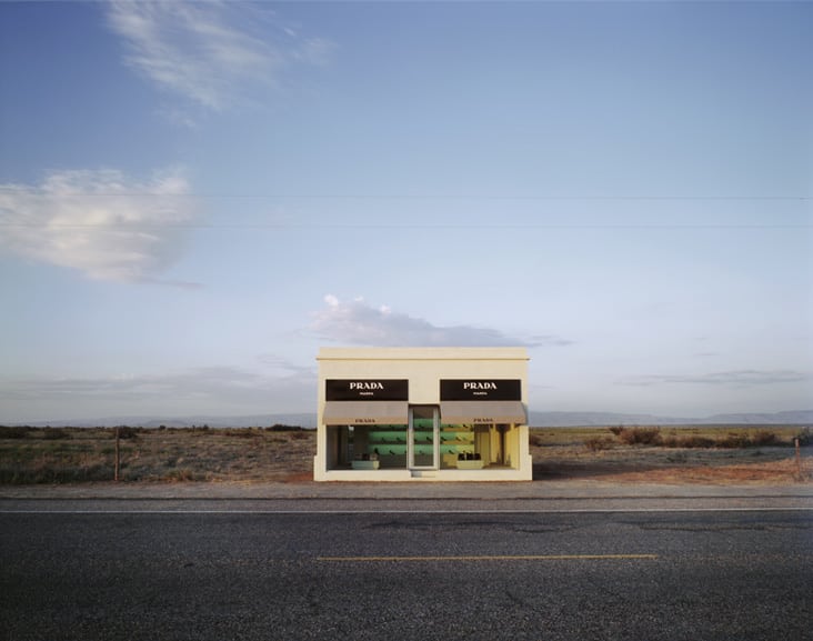 Prada Marfa, 2005. Adobe bricks, plaster, aluminium frames, glass panes, MDF, paint, carpet, Prada shoes and bags, 760 x 470 x 480 cm