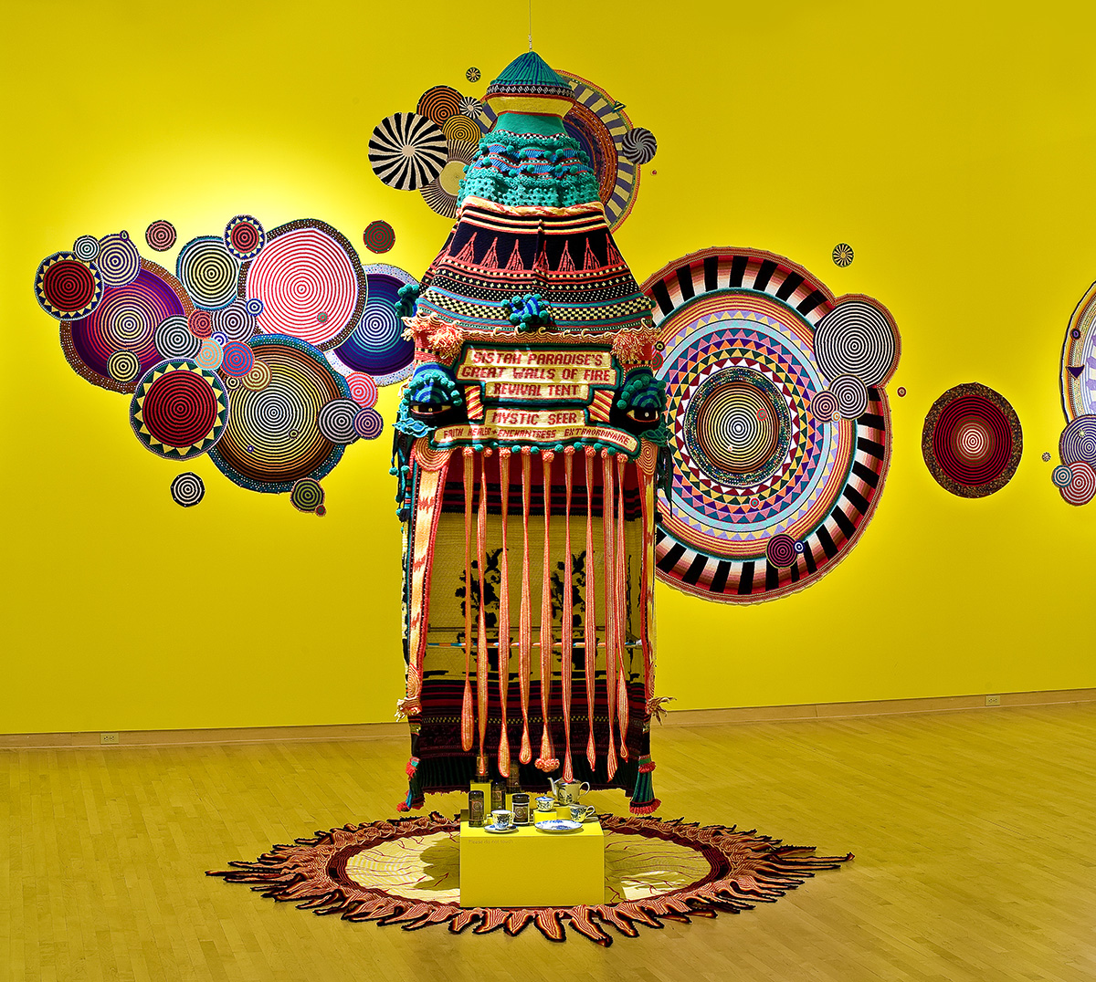 Xenobia Bailey, Sistah Paradise's Great Wall of Fire Tent (installation view, John Michael Kohler Arts Center), 1993; acrylic and cotton yarn and mixed media. Courtesy of the artist.