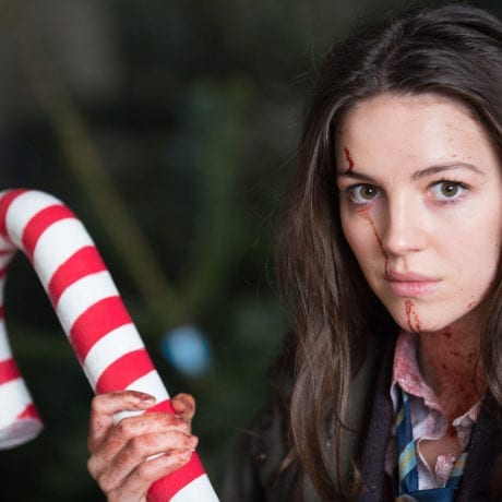 Ella Hunt (Anna) in the Christmas Tree Emporium with her candy cane as a weapon