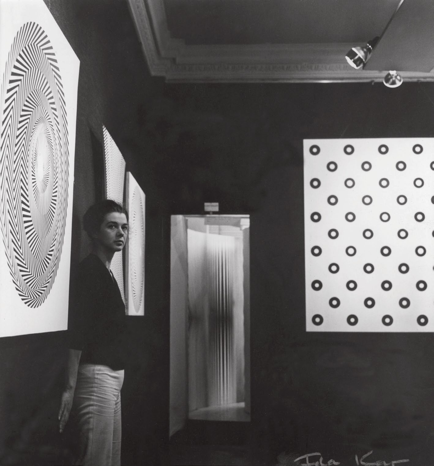 Bridget Riley in her second solo exhibition at Gallery One, London, photo by Ida Kar. Image from the book Bridget Riley A Very Very Person.