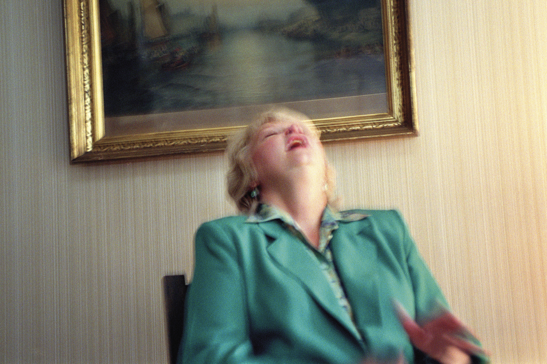 Gretchen Clark laughs as her deceased brother Chapman interrupts a reading to tell her a joke, Lily Dale, New York, 2001. From SÃ©ance by Shannon Taggart