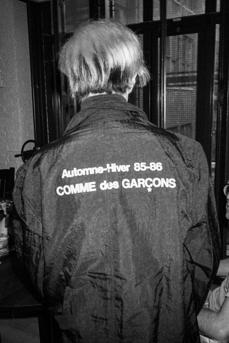 Andy Warhol modeling his new Comme des Garçons jacket at the Con Edison building, New York 1985