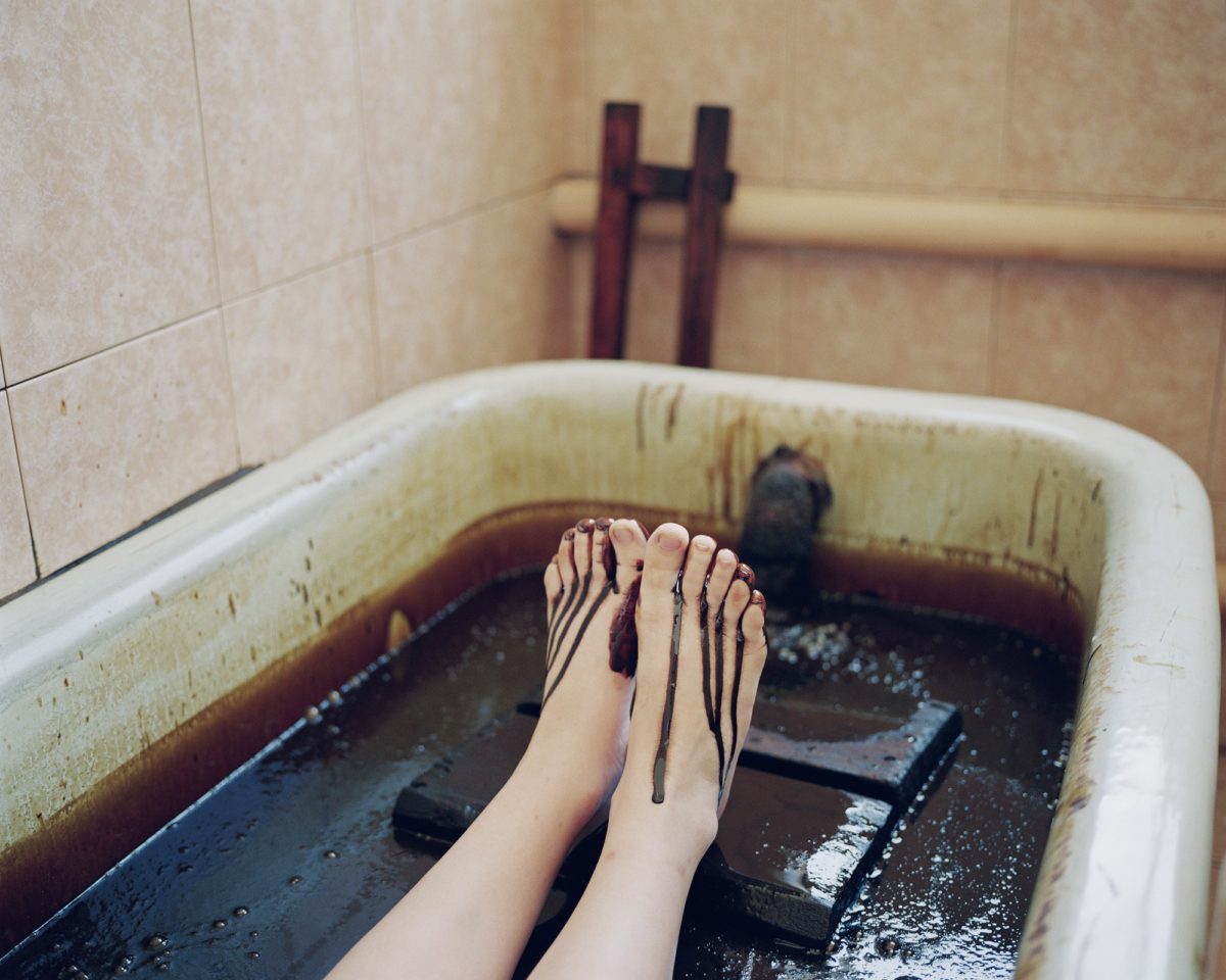Chloe Dewe Matthews, ‘A young woman bathes in crude oil at the sanatorium town of Naftalan.’ Naftalan, Azerbaijan, 2010