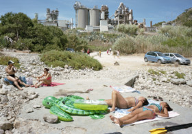 Throughout the series, which has just been published as a book by Mack, sun-seekers set up camp in car parks; swimming pools appear as mini oases in a desert of grey concrete; and cranes and cooling towers loom awkwardly over beaches. The contrast between these built up, man-made environments and the sunbathers, who appear minute in scale, is amusingly surreal, but highlights our subservience towards industry, housing developments and superstores.
