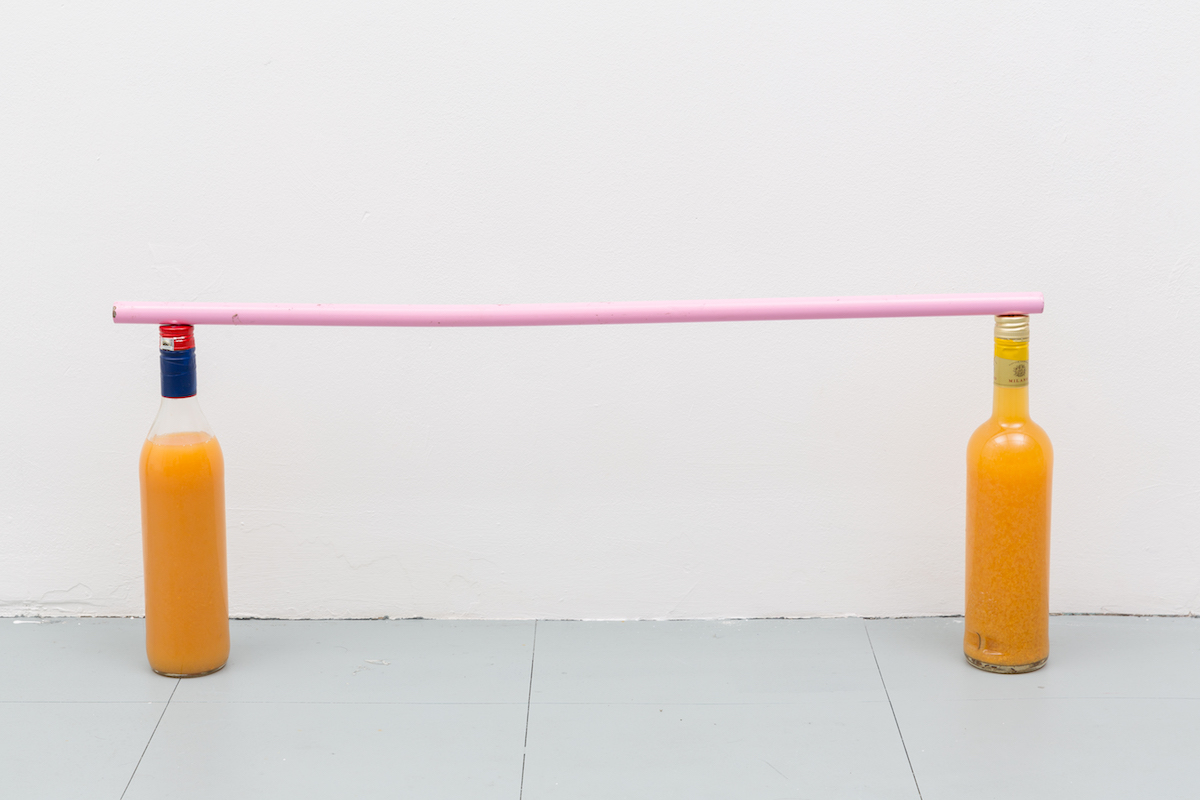 Guillaume Vandame, Gloria, 2019, found bottles with mysterious orange liquid, found pink metal pole