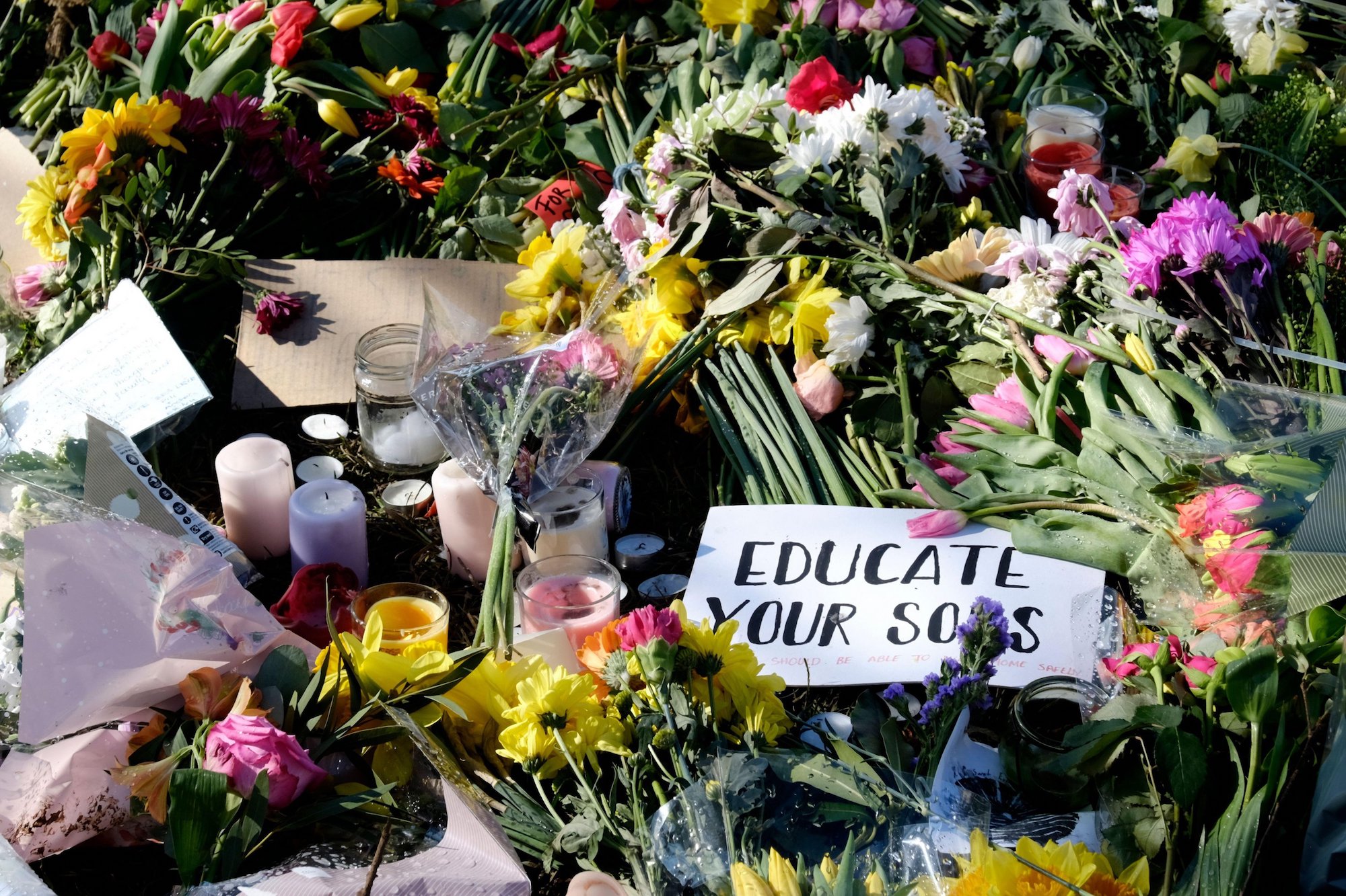 College Green, Bristol, UK. 16th Mar 2021. Floral tributes laid during the reclaim the Streets vigil for Sarah Everard. Courtesy JMF News/Alamy Live News