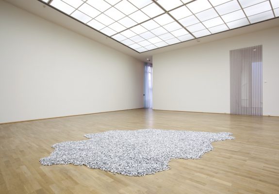 "Untitled" (Placebo), 1991. Candies in silver wrappers, endless supply. Overall dimensions vary with installation. Ideal weight: 1,000 - 1,200 lb. © Felix Gonzalez-Torres. Courtesy of the Felix Gonzalez-Torres Foundation. Installed in Felix Gonzalez-Torres: Specific Objects without Specific Form. MMK Museum für Moderne Kunst, Frankfurt, Germany. 28 Jan. – 14 Mar. 2011. Photo: Axel Schneider, Frankfurt-am-Main