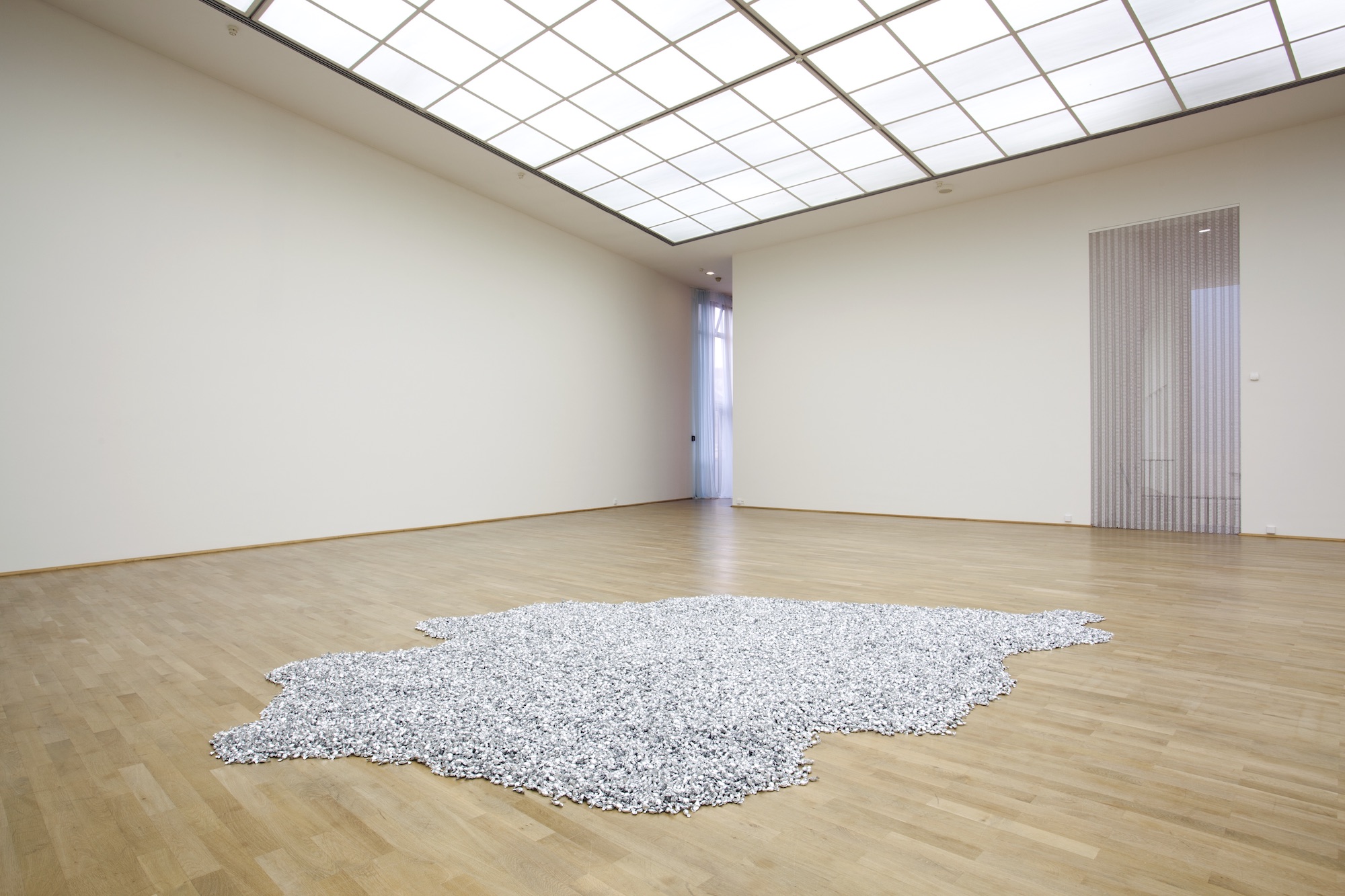 "Untitled" (Placebo), 1991. Candies in silver wrappers, endless supply. Overall dimensions vary with installation. Ideal weight: 1,000 - 1,200 lb. Â© Felix Gonzalez-Torres. Courtesy of the Felix Gonzalez-Torres Foundation. Installed in Felix Gonzalez-Torres: Specific Objects without Specific Form. MMK Museum fuÌˆr Moderne Kunst, Frankfurt, Germany. 28 Jan. â€“ 14 Mar. 2011. Photo: Axel Schneider, Frankfurt-am-Main