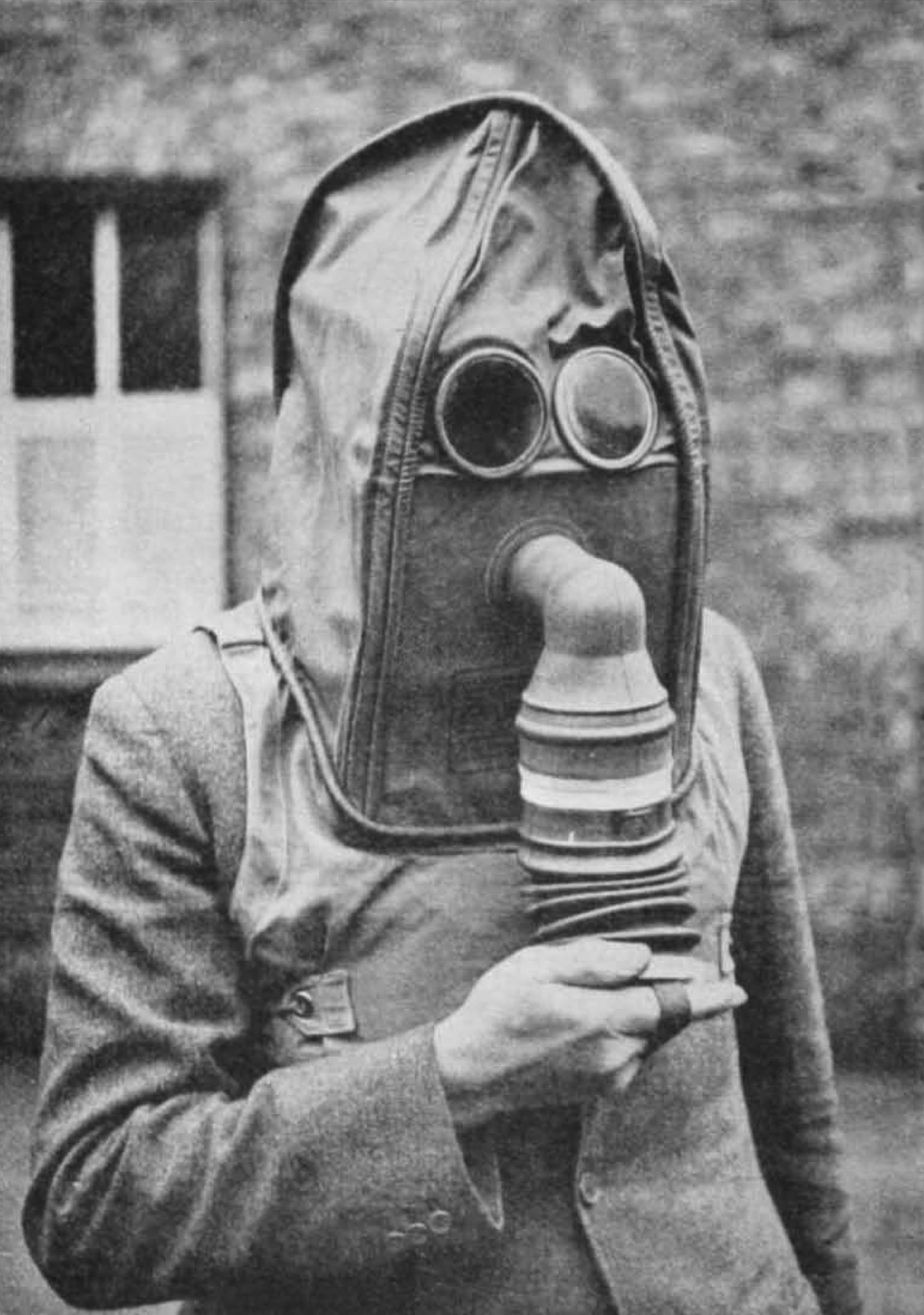 Civil Defence Manual of Basic Training: Basic Chemical Warfare (1949). Helmet respirator, showing the wearer operating the bellows