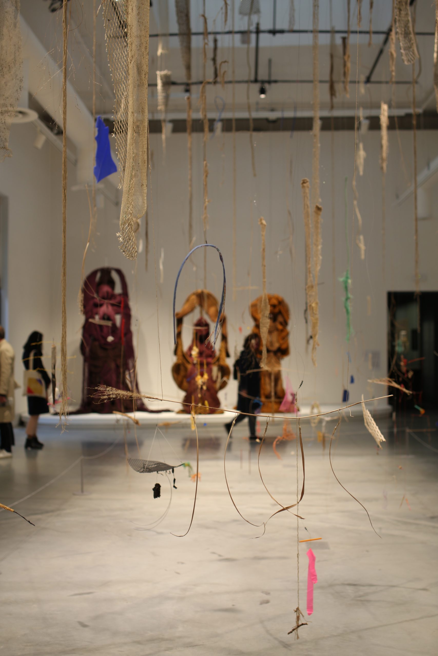 Cecilia Vicuña installation (foreground), Mrinalini Mukherjee rope sculptures (background) at the Giardini central pavilion. Photo by Louise Benson
