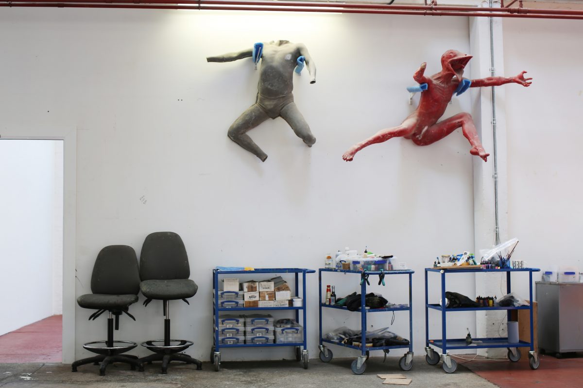 Wall-hanging mannequins overlook the upstairs studio