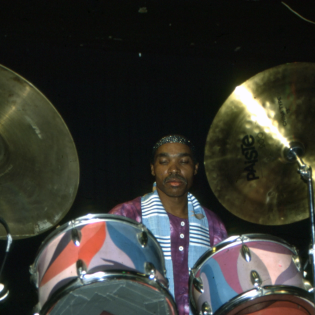 Ayé Aton playing his custom-painted drum set at the Bayou in Houston, Texas, circa 1990. Ayé Aton Personal Archives.