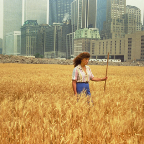 Wheatfield - A Confrontation: Battery Park Landfill, Downtown Manhattan - With Agnes Denes Standing in the Field, 1982 Photo: John McGrail. Courtesy Agnes Denes and Leslie Tonkonow Artworks + Projects